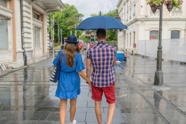 istock Young couple walking down the street on a rainy day 856589746