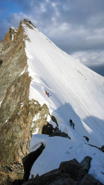 istock moutain climbers approaching a summit inthe Swiss Alps 856592440