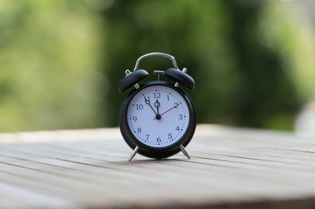 istock Retro alarm clock with five minutes to twelve o'clock. 856592924