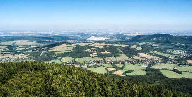 view from Velky Javornik hill in Moravskoslezske Beskydy mountains in Czech republic view to north from Velky Javornik hill in Moravskoslezske Beskydy mountains with countryside, villages, small hills and giant limestone quarry on Kotouc hill in Czech republic moravian silesian beskids photos stock pictures, royalty-free photos & images