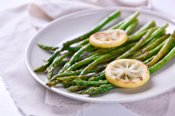 istock Freshly baked asparagus with lemon slice. 856596466