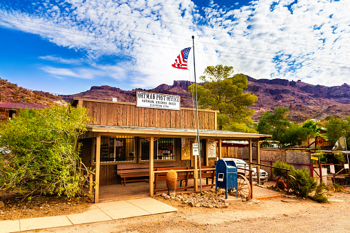 Oatman Historic US Post Office in Oatman, Arizona, United States. The colorful picture shows the post office located at famous Highway Route 66 in front of the black mountains.