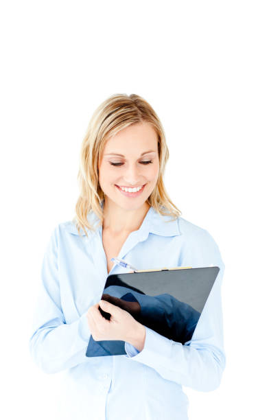 istock Glowing young businesswoman taking notes on her clipboard 856599646