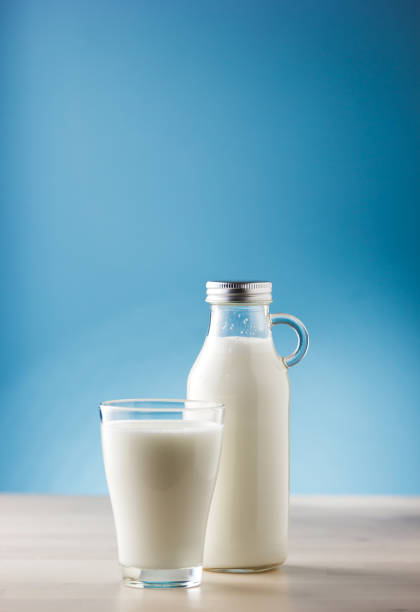 istock Jar and glass of milk, front view 856600220