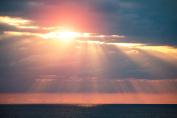 istock Rays of sun through the clouds over the sea 856600304
