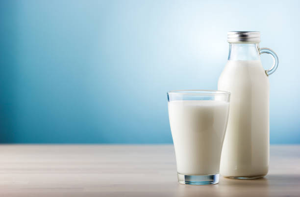 istock Jar and glass of milk, front view 856600558