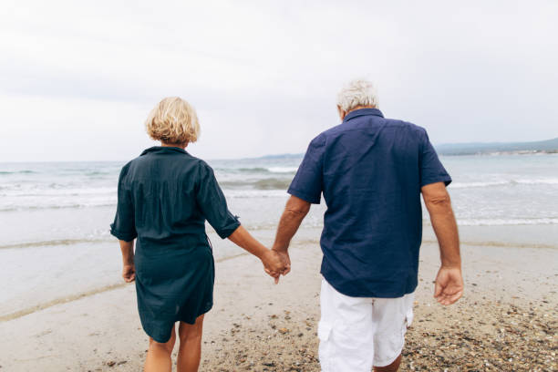 istock Senior couple on a walk by the sea 856604542