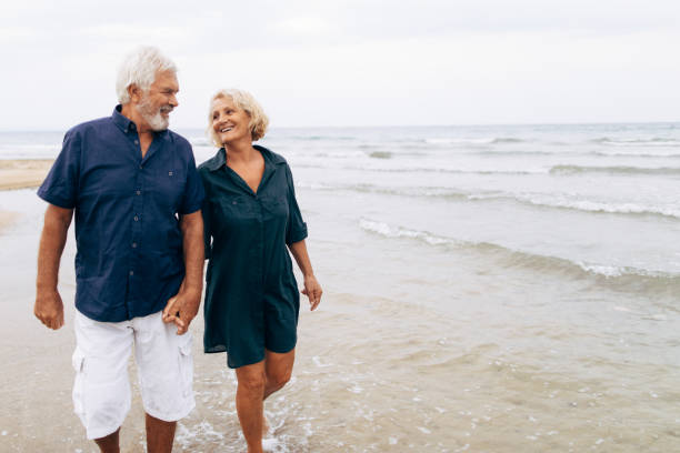 istock Senior couple on a walk by the sea 856604646