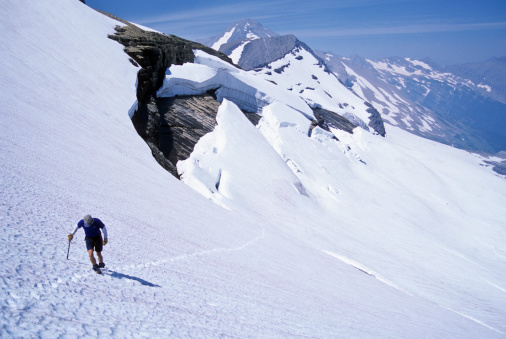Man climbing snowfield. photo