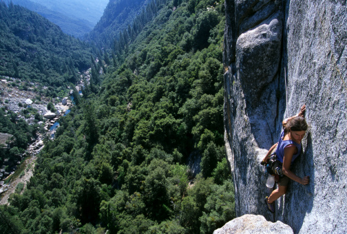 Female climber leading trad route in Yosemite National Park, CA.
