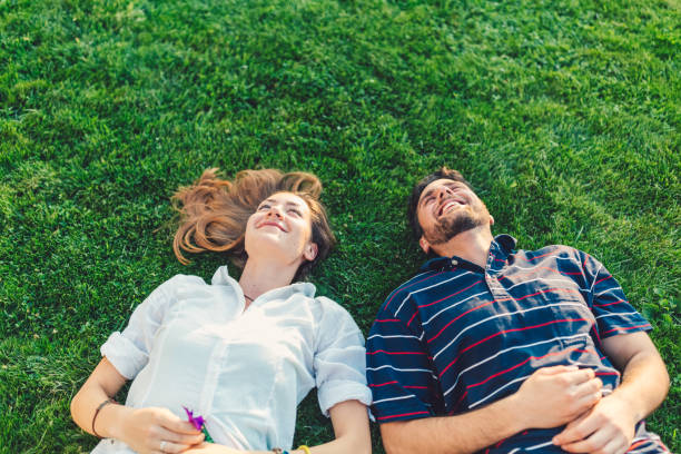 istock Happy couple in the grass dreaming 856607862
