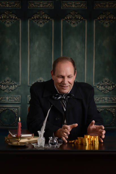 istock greedy victorian miser happy with pile of money 856608094