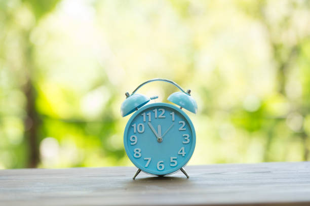 istock Retro alarm clock with five minutes to twelve o'clock. 856608246