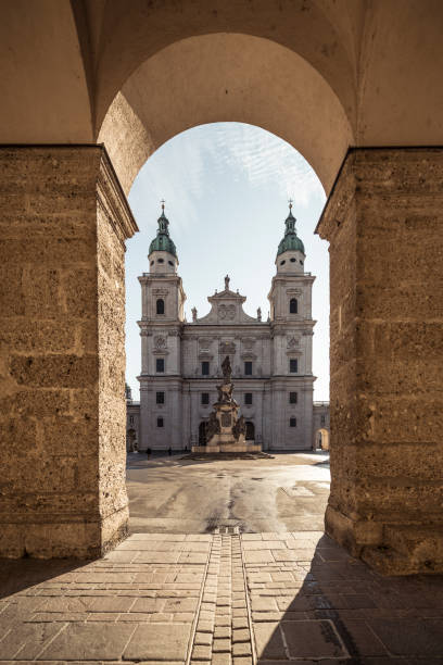 Salzburg Cathedral early morning sunrise in autumn. The cathedral's plaza is a complete aesthetic concept and one of Salzburg's most beautiful urban set pieces. In the center rises the Virgin's Column with a 1771 statue of the Virgin Mary.