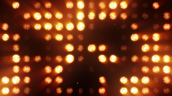 The wall of bright orange incandescent lamps lights up along the pattern