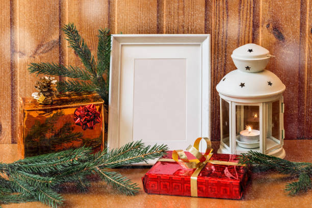 istock White photo frame, lantern and christmas gifts 856611760