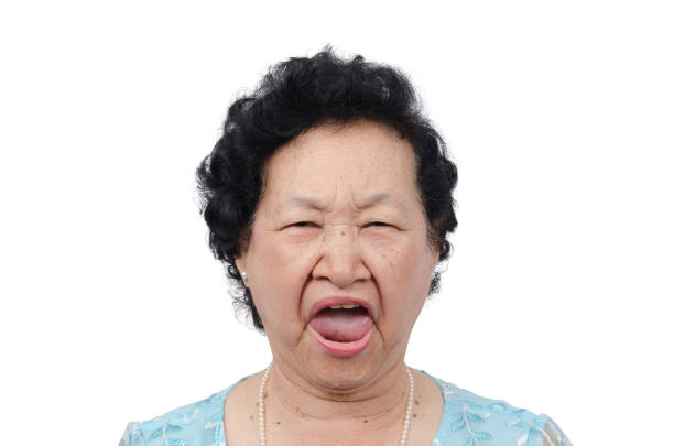 Elderly woman with yawn expression over white background