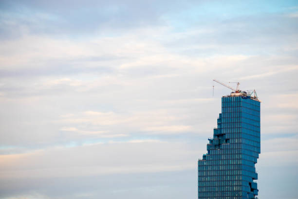 istock Tower building construction site with crane on twilight blue sky background 856611932