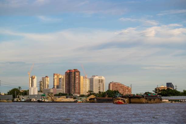 istock Sand barge ship in river and construction site building background, City urbanization and industry concept 856611948