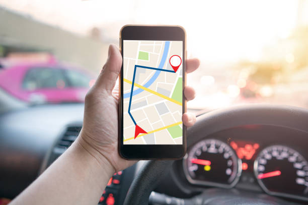 istock man holding mobile phone with map gps navigation application in the car 856615436