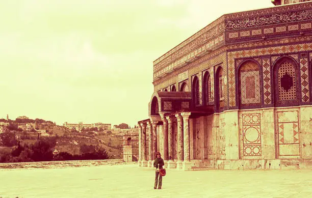Vintage image of a woman  outside the Dome of the Rock in the seventies.