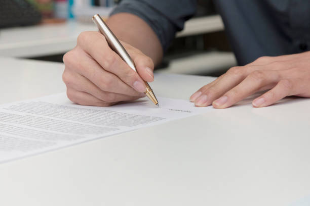 istock businessman hand signing a contract paper 856630652