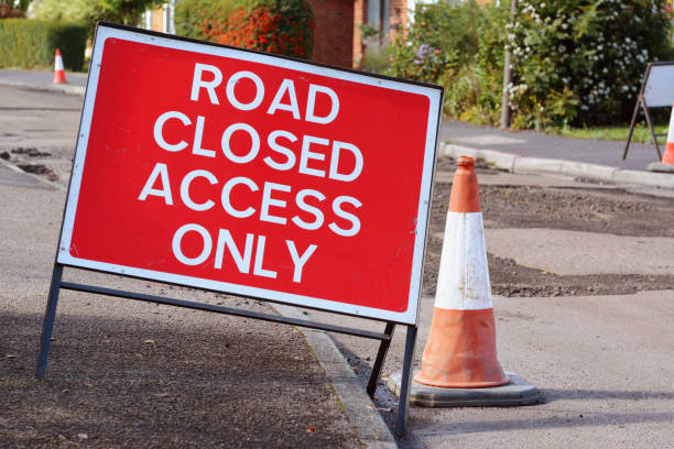 istock ROAD CLOSED ACCESS ONLY road sign with a traffic cone 856631066