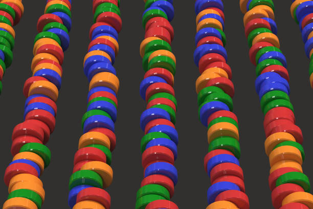 istock Pattern of blue, red and green cylinder tablets on black background 856634156