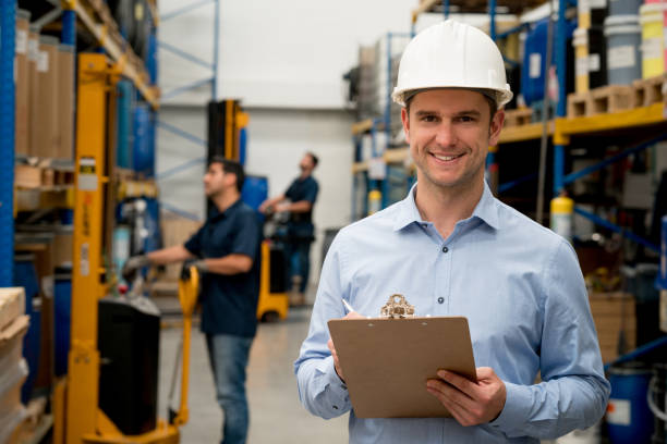 istock Man working at a warehouse leading a group of workers 856634692