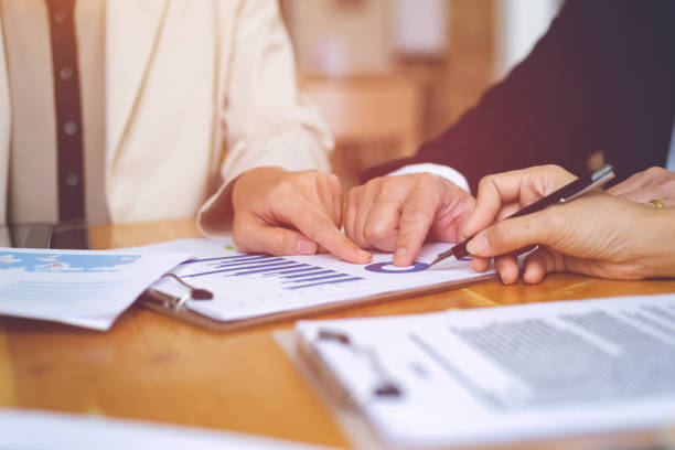 istock Close-up of Business people hands pointing analyzing at the documents income charts and graphs while discussing on office. Teamwork successful Meeting Workplace strategy with graph financial diagram. 856635012