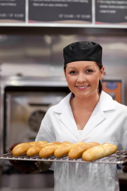 istock Pretty young baker with baguettes 856637916
