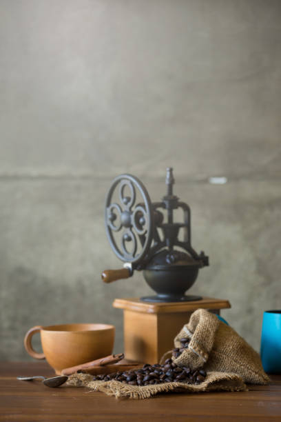istock Vintage manual coffee grinder with coffee beans and cup 856638694