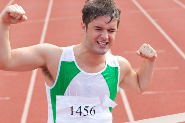 istock Ecstatic sprinter showing expression of victory in front of the arrival line 856642376