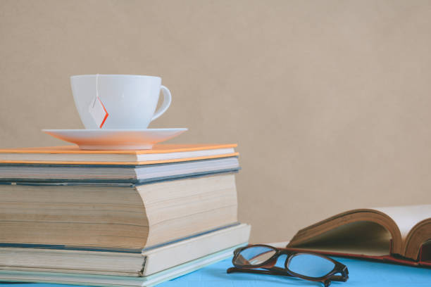 istock Book glasses and tea on the desk with study and education concept 856645248