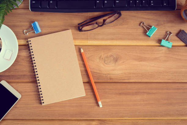 istock top view desk wood and office equipment 856645390