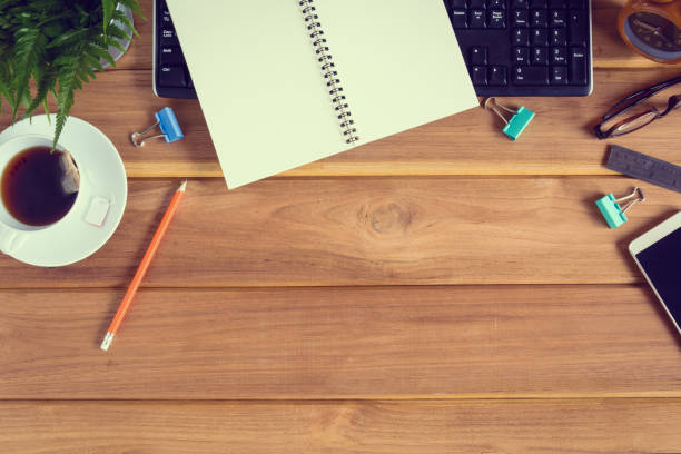 istock top view desk wood and office equipment 856645400