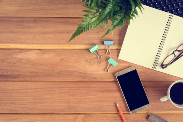 istock top view desk wood and office equipment 856645418
