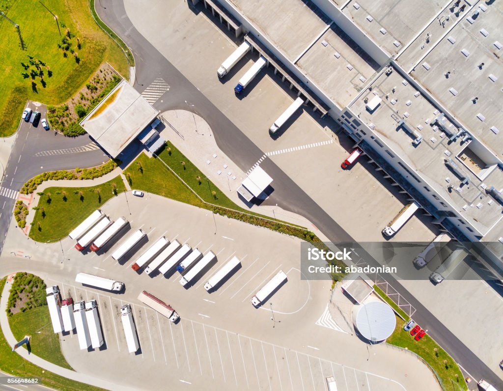 Aerial view of warehouse with trucks. Aerial view of warehouse with trucks. Industrial background. Logistics from above. Aerial View Stock Photo