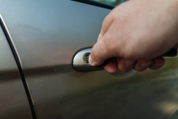 istock man's hand opens the car door with a key 856648834