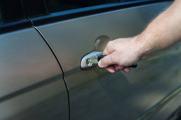 istock man's hand opens the car door with a key 856648838