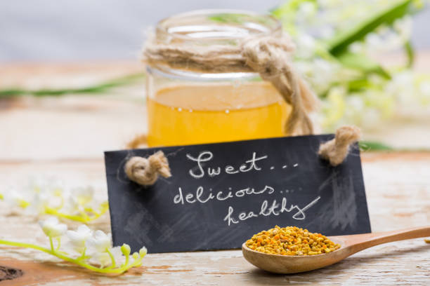 istock Honey and bee pollen on wooden table 856653774