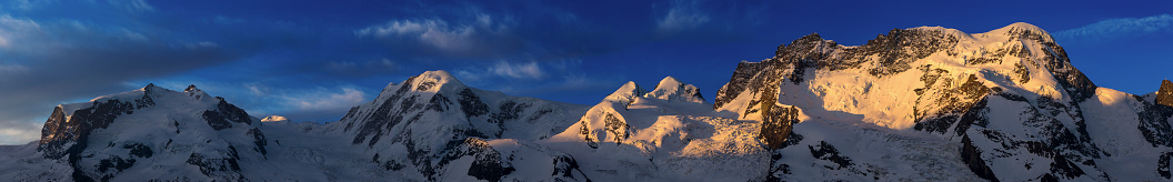 Panoramic view of Mount Rosa massive from Gornergrat at dawn. Switzerland.
