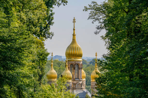 The golden onion domes of the Griechische Kapelle, aka Russisch-Orthodoxe Kirche with city of Wiesbaden, Germany in the valley below.