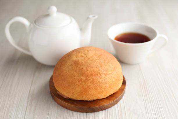 istock round bread and English tea teacup and teapot isolated on table 856659614