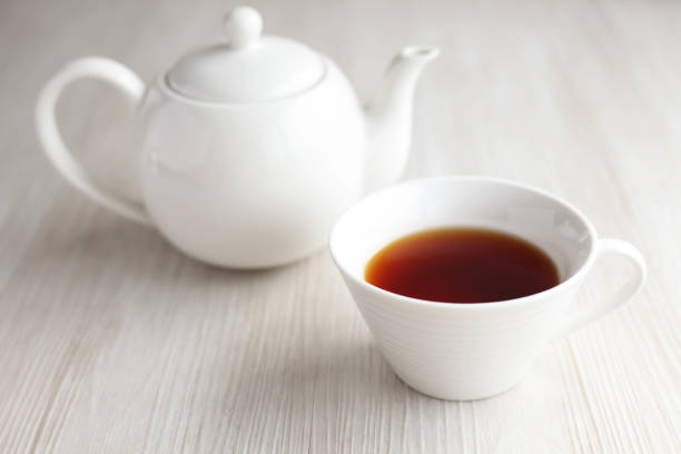 istock English tea cup and teapot isolated on table 856659668