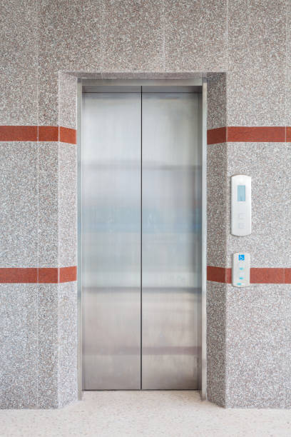 istock Modern steel elevator with closed doors in business building office. 856665356