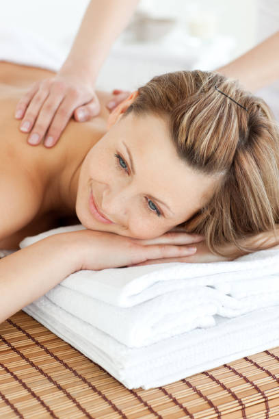 istock Cute young woman having a back massage in a spa center 856666122