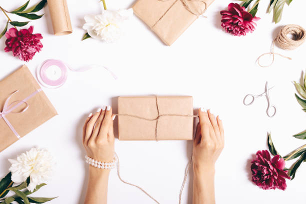 istock Top view of female hands wrapping presents 856668354