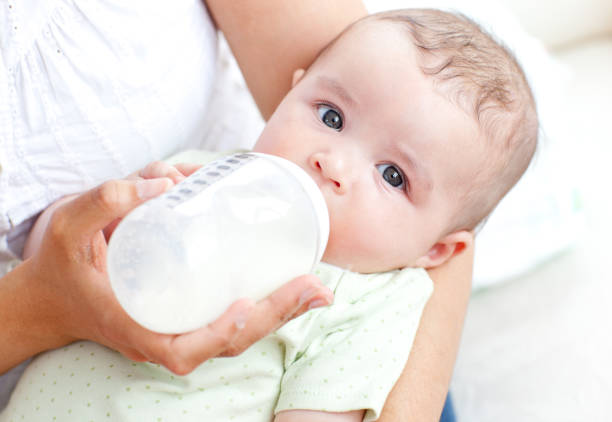 istock Charming mother feeding her adorable son in the kitchen 856669372