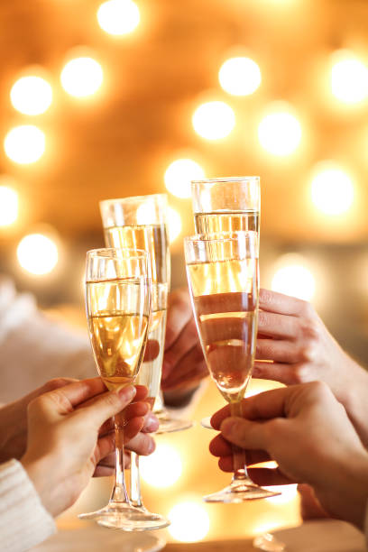 istock Champagne glasses in hands on golden background 856672018